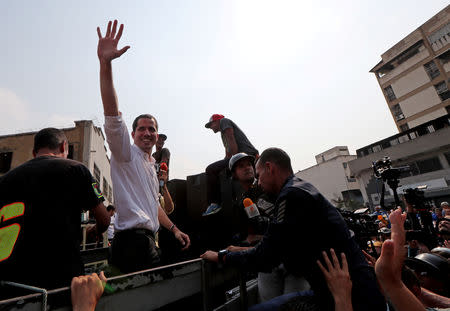 Venezuelan opposition leader Juan Guaido, who many nations have recognized as the country's rightful interim ruler, greets his supporters as he takes part in a protest against Venezuelan President Nicolas Maduro's government in Caracas, Venezuela, April 10, 2019. REUTERS/Ivan Alvarado