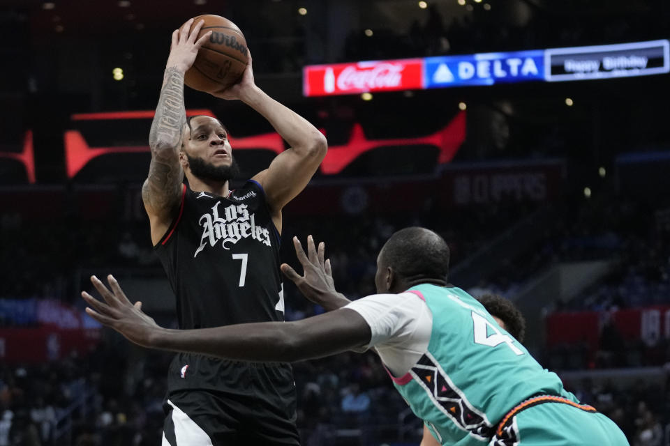 Los Angeles Clippers guard Amir Coffey (7) shoots against San Antonio Spurs center Gorgui Dieng (41) during the second half of an NBA basketball game in Los Angeles, Thursday, Jan. 26, 2023. (AP Photo/Ashley Landis)