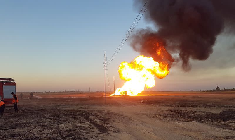 Fire and plumes of smoke are seen from an explosion on the Arab Gas Pipeline between the towns of Ad Dumayr and Adra, northwest of the capital of Damascus