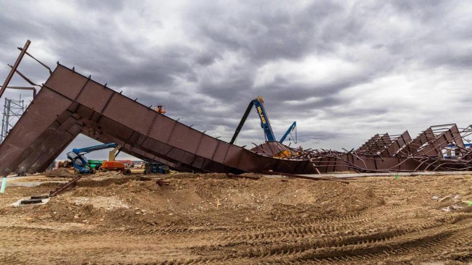 At the construction site where a building collapsed Wednesday near the Boise Airport, wreckage shows twisted girders with a crane in the center. Three workers died at the scene and nine others were injured. The project was an airplane hangar for Jackson Jet Center.