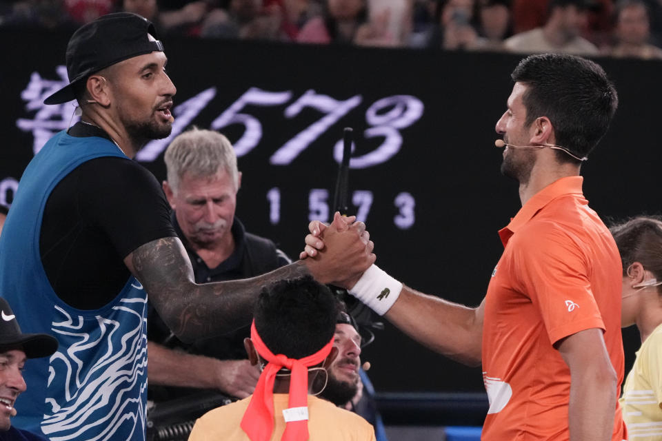 Australia's Nick Kyrgios, left, and Serbia's Novak Djokovic shake hands following an exhibition match on Rod Laver Arena ahead of the Australian Open tennis championship in Melbourne, Australia, Friday, Jan. 13, 2023. (AP Photo/Mark Baker)