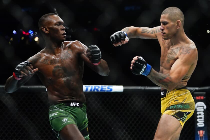 FILE - Brazil's Alex Pereira, right, fights Nigeria's Israel Adesanya during the first round of a middleweight title fight at the UFC 281 mixed martial arts event, Sunday, Nov. 13, 2022, in New York. No. 1 title contender Israel Adesanya faces champion Alex Pereira for the middleweight belt on Saturday, April 8, 2023, in Miami in UFC 287. Pereira knocked out Adesanya in the fifth round in November. (AP Photo/Frank Franklin II, File)