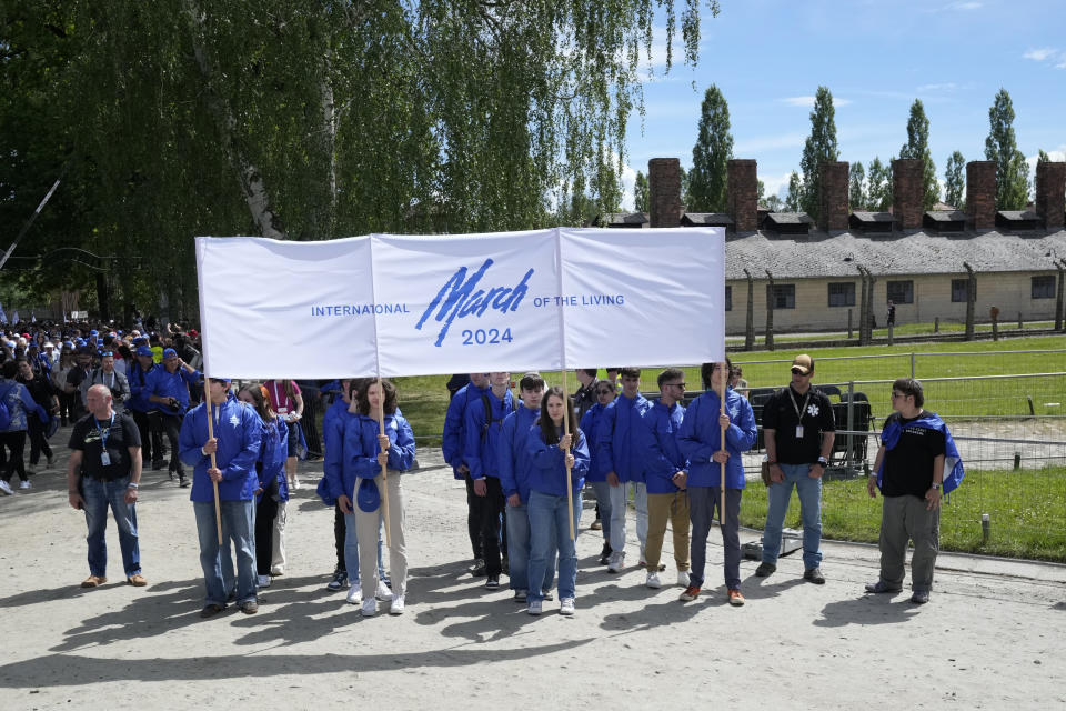 People walk through the former Nazi German death camp of Auschwitz-Birkenau as they attend the annual Holocaust remembrance event, the "March of the Living" in memory of the six million Holocaust victims in Oswiecim, Poland, Monday, May 6, 2024. The event comes amid the dramatic backdrop of the violence of the Israel-Hamas war after the Oct. 7 Hamas attack, the deadliest violence against Jews since the Holocaust, and as pro-Palestinian protests sweep U.S. campuses. (AP Photo/Czarek Sokolowski)