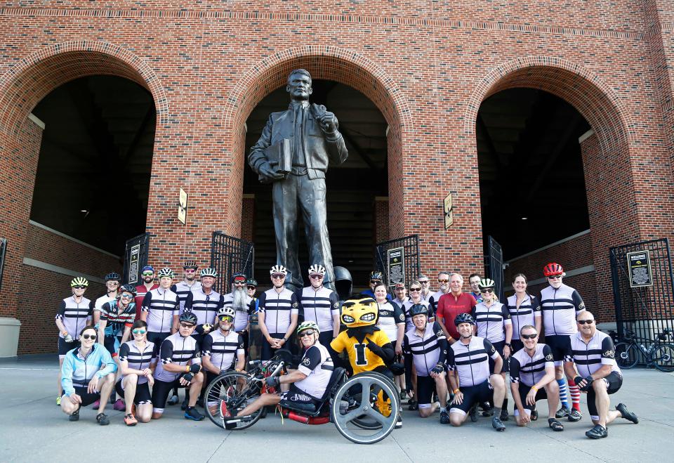 Cyclists pause for a photo with the statue of Nile Kinnick during the RAGBRAI route inspection on June 10, 2023. RAGBRAI riders will head through the concourse of Kinnick Stadium in the early morning hours to open the final day of the 50th anniversary ride on Saturday, July 29.
