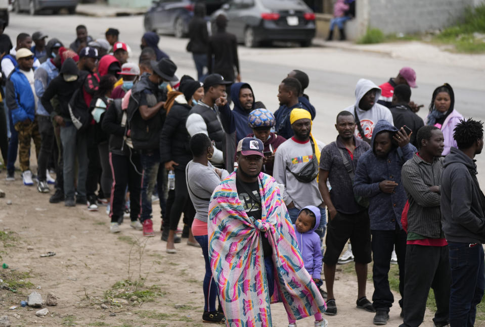 Haitian migrants hoping to apply for asylum in the U.S., gather along the U.S. Mexico border, as they wait to register with a religious organization, in Reynosa, Mexico, Wednesday, Dec. 21, 2022. (AP Photo/Fernando Llano)