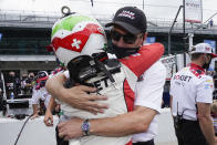 Tim Cindric, front right, hugs Simona De Silvestro, left, of Switzerland, after De Silvestro qualified for the Indianapolis 500 auto race at Indianapolis Motor Speedway, Sunday, May 23, 2021, in Indianapolis. (AP Photo/Darron Cummings)