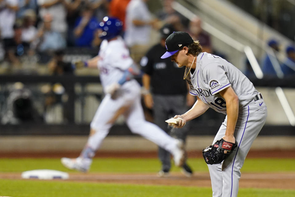 Colorado Rockies starting pitcher Ryan Feltner, right, reacts as New York Mets' Pete Alonso runs the bases after hitting a two-run home run during the third inning of a baseball game Thursday, Aug. 25, 2022, in New York. (AP Photo/Frank Franklin II)