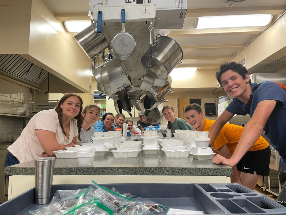 Youth group members prepare to take meals to church shut-ins.