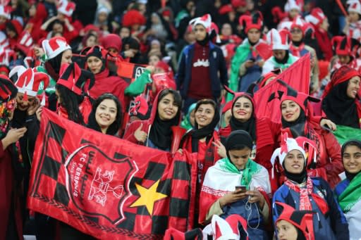 Iranian women cheer Persepolis football giant during the second leg of the AFC Champions League final football match between the local side and Japan's Kashima Antlers on November 10, 2018 at the Azadi Stadium in Tehran