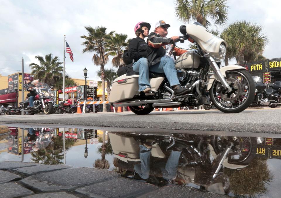 Riders cruise along Main Street past puddles from a early morning rain shower on Friday's opening day of the 83rd annual Bike Week in Daytona Beach. Although there's the prospect for more rain this week, it didn't dampen the spirits of Bike Week visitors Friday. "It was snowing and 20 degrees when I left," said Chris Snyder, who traveled from Buffalo for the event.