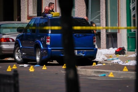 Officials investigate the scene after a mass shooting in Dayton