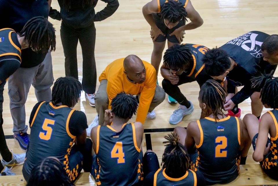 Peoria Quest Gators head coach Ron Ingram consults closely with his team during the first quarter break in the first half of their Class 1A boys basketball regional semifinal Wednesday, Feb. 21, 2024 at Illini Bluffs High School in Glasford. The Tigers advanced to the final with a 65-43 win. Peoria Public Schools has declined to renew its contract with Peoria Quest Charter Academy, so the school will close at the end of the year and the remaining students will be moved to other high schools in the district.