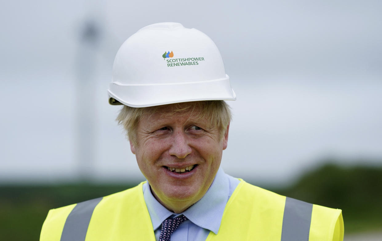 Britain's Prime Minister Boris Johnson gestures during a visit to the Scottish Power Carland Cross Windfarm in Newquay, Cornwall on June 9, 2021, where he viewed new construction on a solar farm. (Photo by Jon Super / POOL / AFP) (Photo by JON SUPER/POOL/AFP via Getty Images)