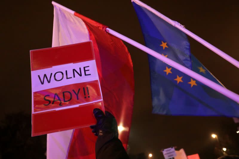 People take part in an anti-government protest in support of free judiciary in Warsaw