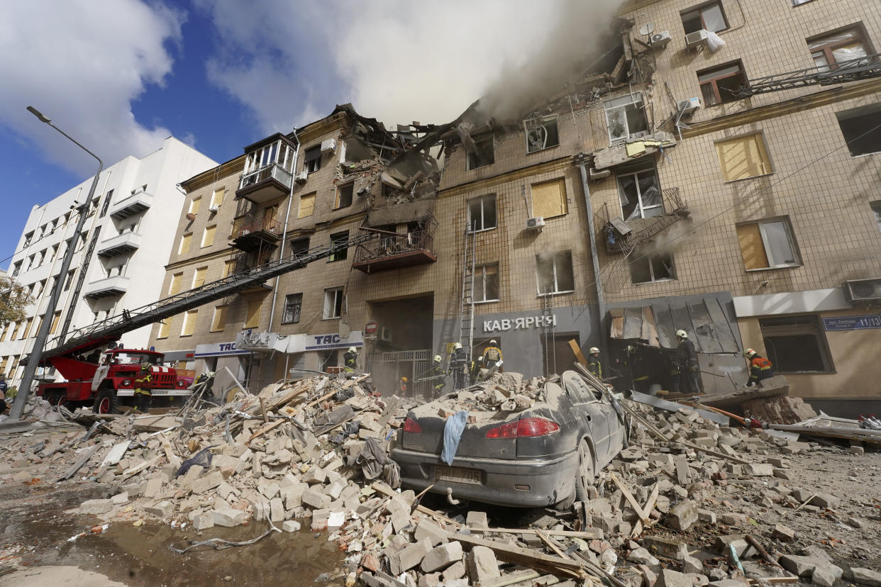 Ukrainian firefighters work on heavily damaged buildings after latest Russian rocket attack in center Kharkiv, Ukraine, Tuesday, Sept. 6, 2022. (AP Photo/Andrii Marienko)