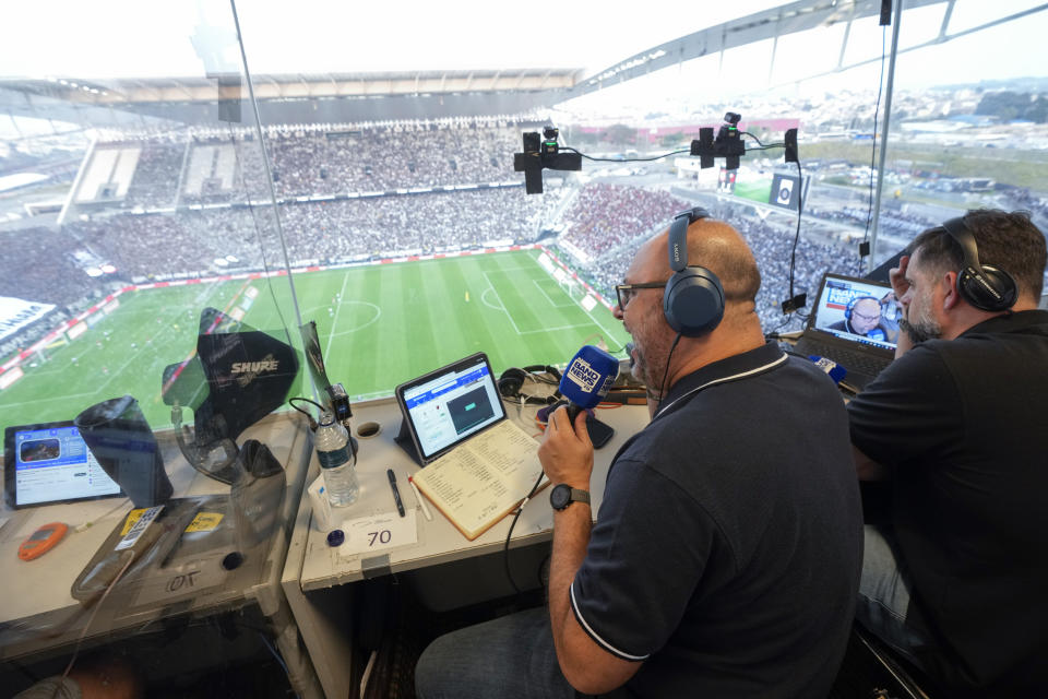 Radio sports commentator Marcelo do Ó works in a press box during a Brazilian soccer league match at the NeoQuimica Arena in Sao Paulo, Brazil, Sunday, Sept. 1, 2024. Local commentators and experts in Brazil will host its first ever NFL match on Sept. 6, 2024. (AP Photo/Andre Penner)