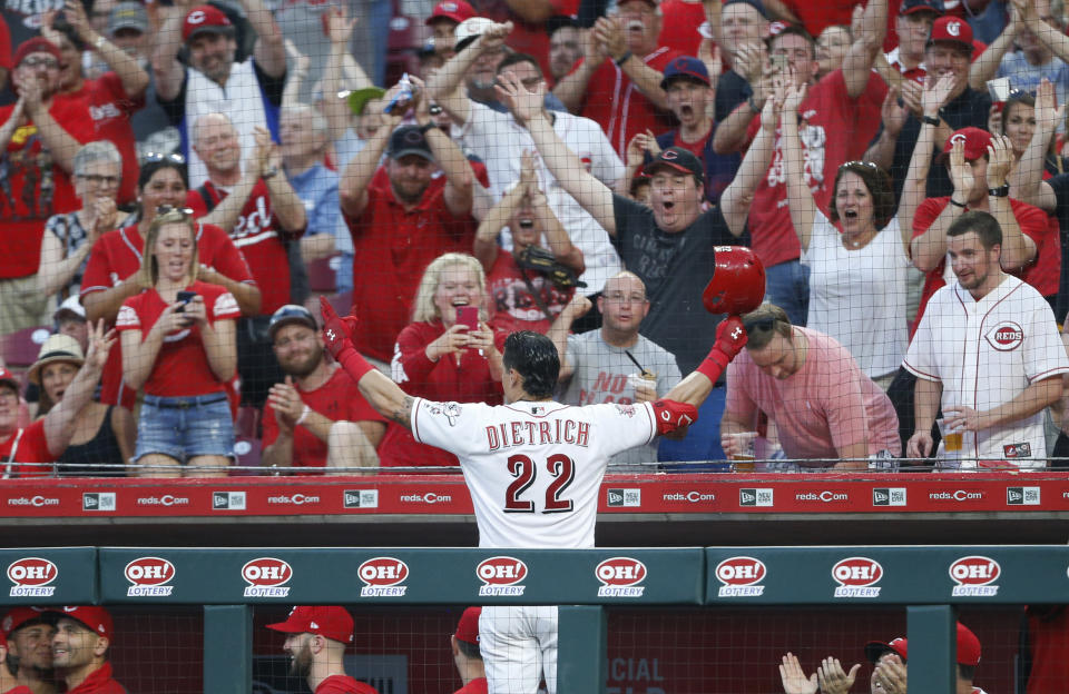El jugador de los Rojos de Cincinnati, Derek Dietrich (22), saluda a los aficionados tras conectar su tercer jonrón de dos carreras durante el séptimo inning de un juego de béisbol contra los Piratas de Pittsburgh, el martes 28 de mayo de 2019, en Cincinnati. (AP Foto/Gary Landers)