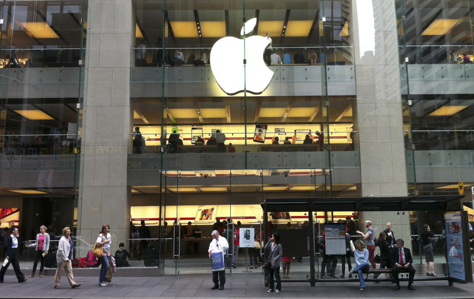 People walk past an Apple store in Sydney's central business district in Australia, Tuesday, Dec. 11, 2012. Australian police are warning the public that errors in Apple's much-maligned mapping application are leading drivers headed to the southern city of Mildura to take a potentially "life-threatening" wrong turn into the middle of a remote state park. Apple's Maps service places the city of Mildura about 70 kilometers (44 miles) away in the Murray Sunset National Park, a desert-like 5,000 square kilometer (1,900 square mile) region with scorching temperatures and virtually no mobile phone reception.(AP Photo/Rob Griffith)