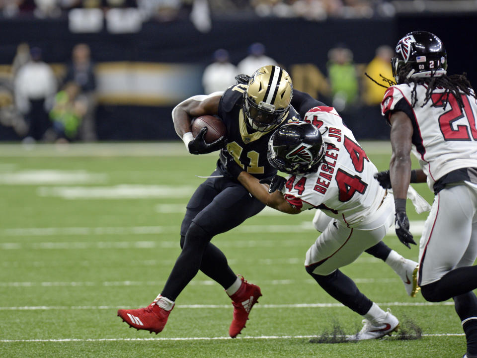 Alvin Kamara, seen here wearing his custom Christmas cleats on Sunday against the Falcons. (AP)