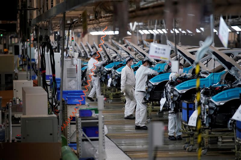 FILE PHOTO: Employees work on a production line inside a Dongfeng Honda factory in Wuhan