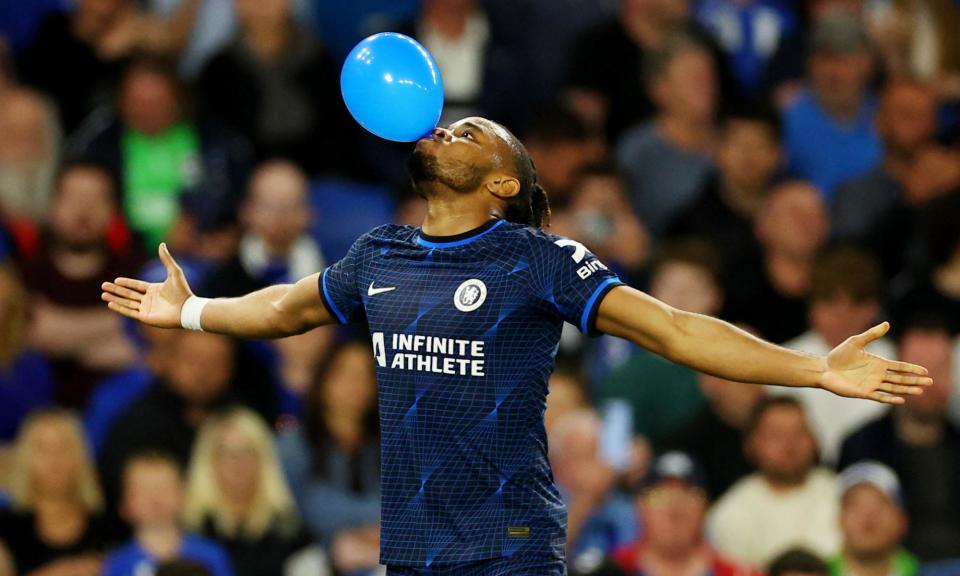 <span>Christopher Nkunku poses with a balloon after he scores Chelsea’s second goal to deflate Brighton.</span><span>Photograph: Toby Melville/Reuters</span>