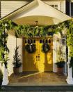 <p>“One can’t have enough greenery for the holidays," says designer <a href="http://www.younghuh.com/" rel="nofollow noopener" target="_blank" data-ylk="slk:Young Huh" class="link ">Young Huh</a>. "We recently moved into an 1820s home and, before we started renovations, decided to gather there for the holidays. We went really big with draped garlands, potted juniper trees, and wreaths with earthy-colored bows. </p><p>Huh says that she brought this organically festive feel into her interior decorating scheme as well for a nice flow that would make all her family and friends feel welcome. We love how the cheery yellow door color pairs with the greenery for a nontraditional holiday look. </p>