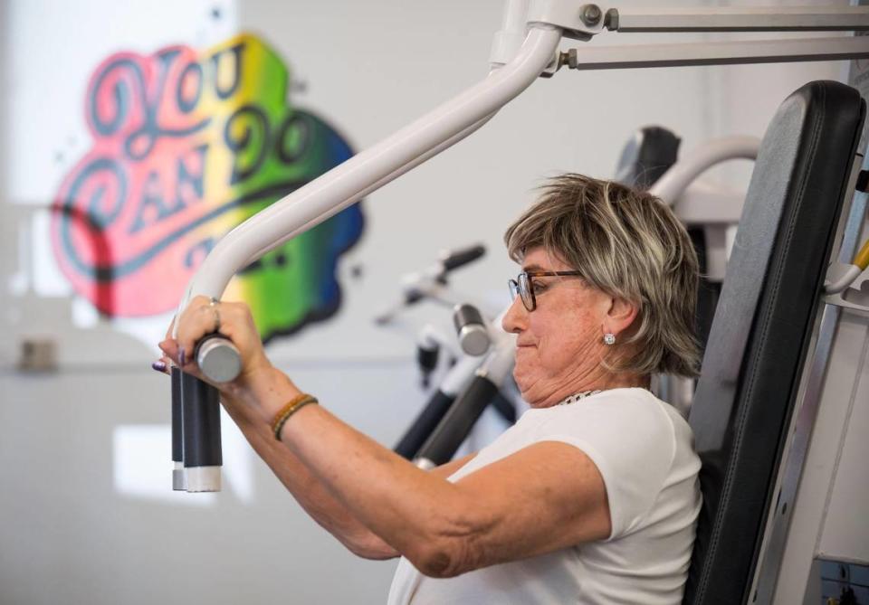 Stephanie Haskins, a transgender woman from Sacramento, works out her upper body at Queers and Allies Fitness on July 7 in East Sacramento. Haskins said she works out practically every day at the gym, regarded as the first of its kind in the area dedicated to serving the LGBTQ community and people currently transitioning.