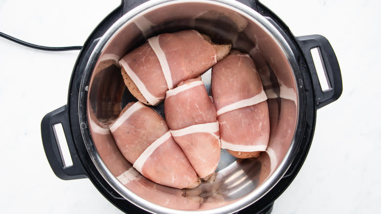 Bacon-wrapped chicken breasts in slow cooker