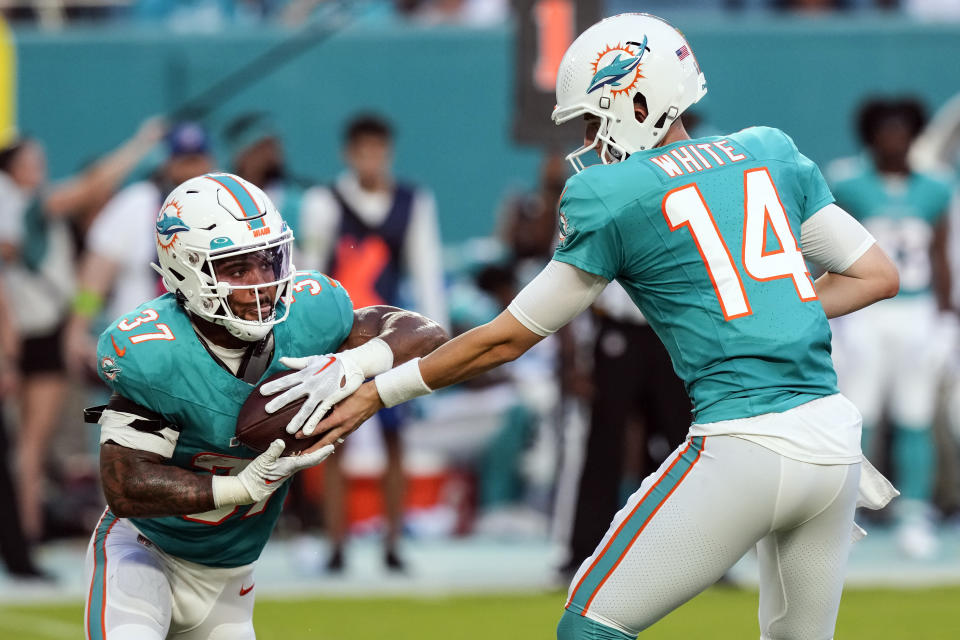 Miami Dolphins quarterback Mike White (14) hands off to Miami Dolphins running back Myles Gaskin (37) in the first half of a preseason NFL football game against the Atlanta Falcons, Friday, Aug. 11, 2023, in Miami Gardens, Fla. (AP Photo/Marta Lavandier)