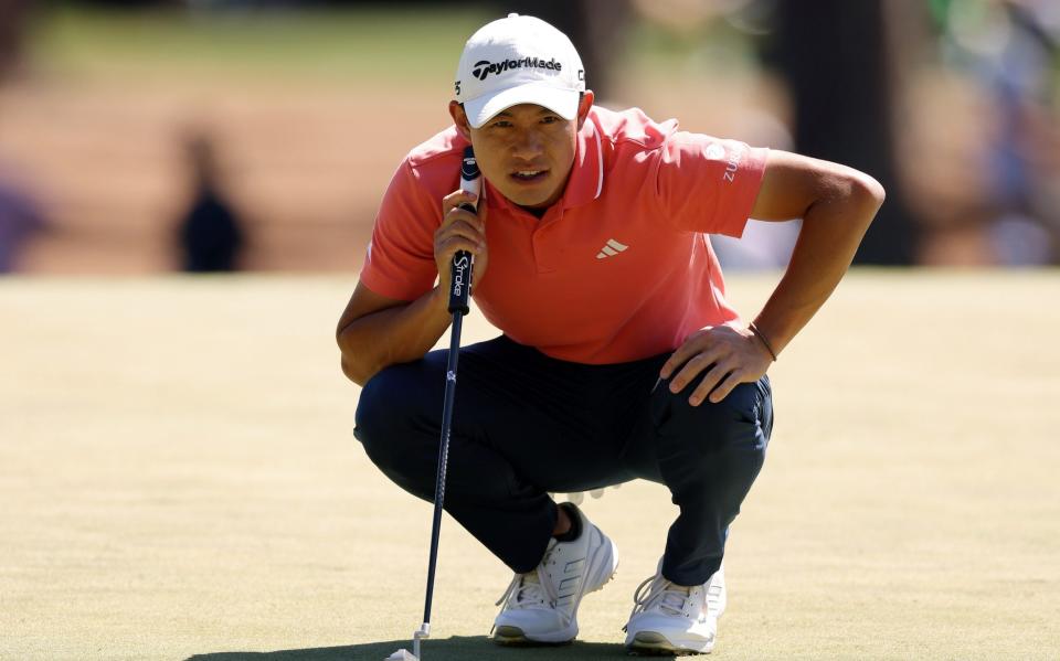 Collin Morikawa lines up a putt