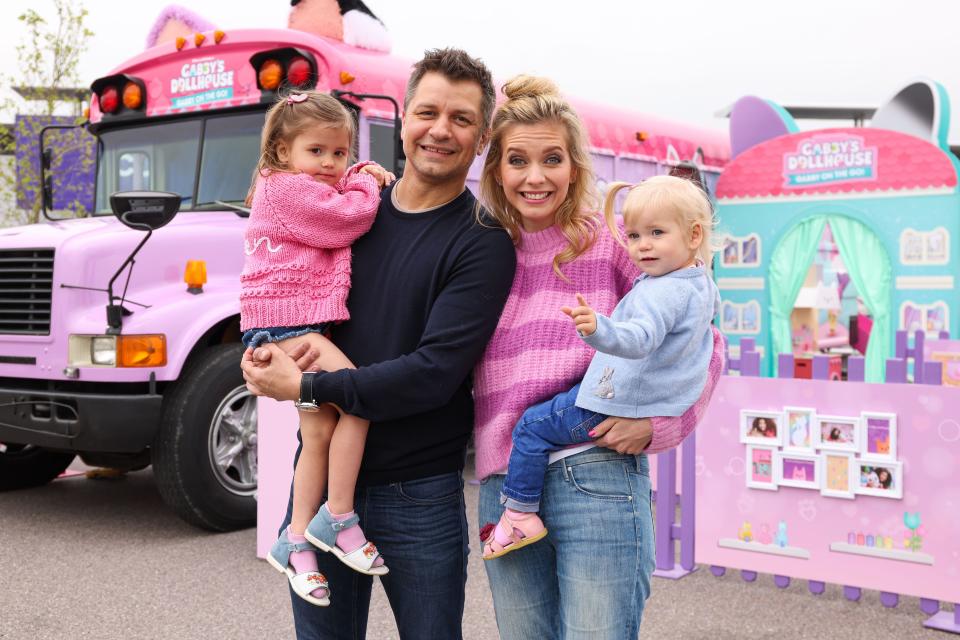 Rachel Riley and Pasha Kovalev with daughters Maven and Noah attend the opening of 'Gabby on the Go!', the Interactive fan experience based around DreamWorks Animation's TV series Gabby's Dollhouse, at Lakeside Retail Park, London. Picture date: Saturday May 13, 2023.