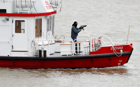 An actor playing an armed terrorist takes part in a training exercise by counter terrorism officers of the Metropolitan Police in a scenario to rescue hostages from a cruise boat on the river Thames, in London, Britain March 19, 2017. REUTERS/Peter Nicholls