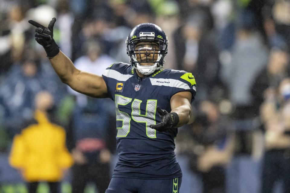 Linebacker Bobby Wagner signals Seahawks teammates.