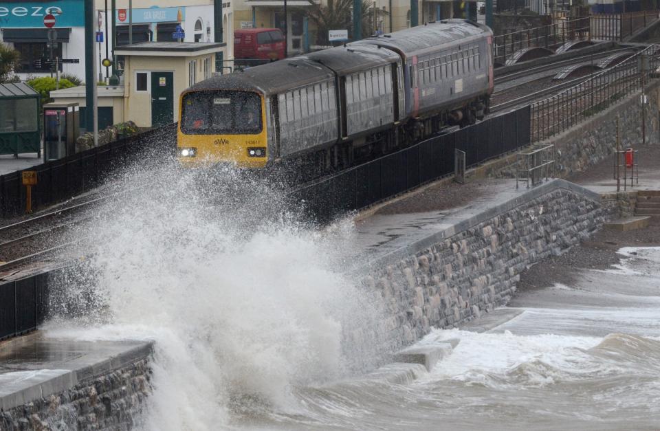 Waves crash against the seafront and railway line in Dawlish. (Getty Images)