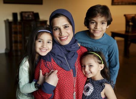 Mirvette Judeh poses for a photo with her children, Ayah Maaytah (L-R), 7, Salma Maaytah, 3, and Rakan Maaytah, 9, at their home in Buena Park, California December 17, 2015. REUTERS/Jason Redmond