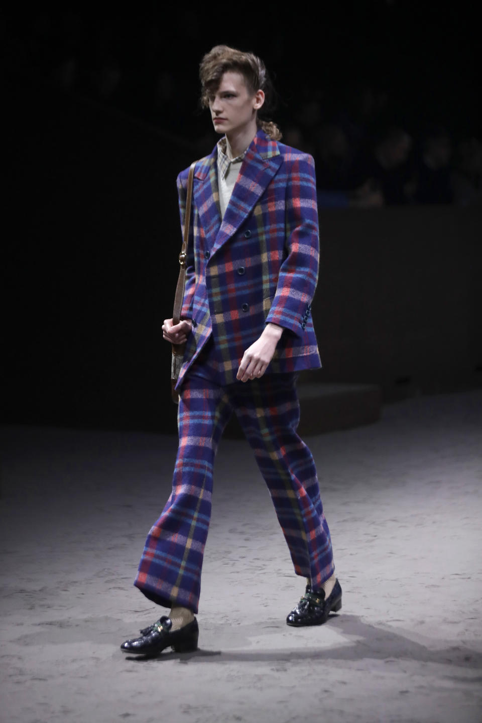 A model wears a creation as part of the Gucci men's Fall-Winter 2020/21 collection, that was presented in Milan, Italy, Tuesday, Jan. 14, 2020. (AP Photo/Luca Bruno)