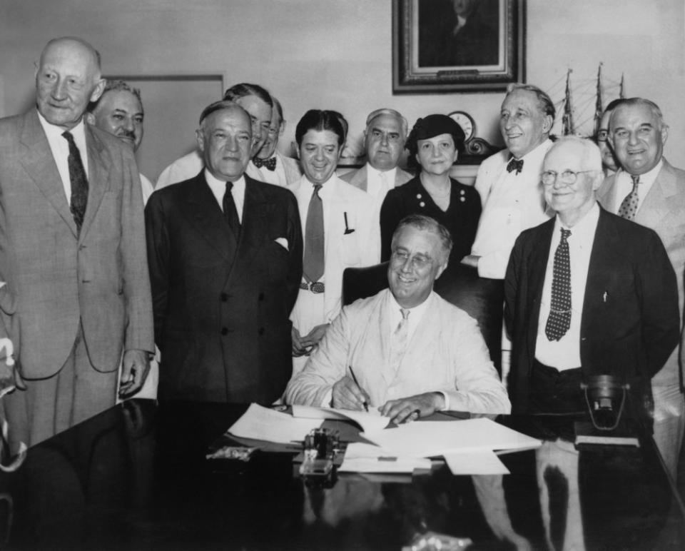 President Franklin D. Roosevelt signs the Social Security Act on Aug. 14, 1935. From left to right, Robert Lee Doughton, chairman of the House Ways and Means Committee, Edwin E. Witte, Director of the President's Social Security Committee, with Senator Robert F. Wagner, co-author of the bill behind him, Senator Robert La Follette, Senator Augustine Lonergan, Labor Secretary Frances Perkins, Senator William H. King, Rep. David John Lewis, co-author of the bill and Senator Joseph F. Guffey. <p>FPG/Getty Images</p>