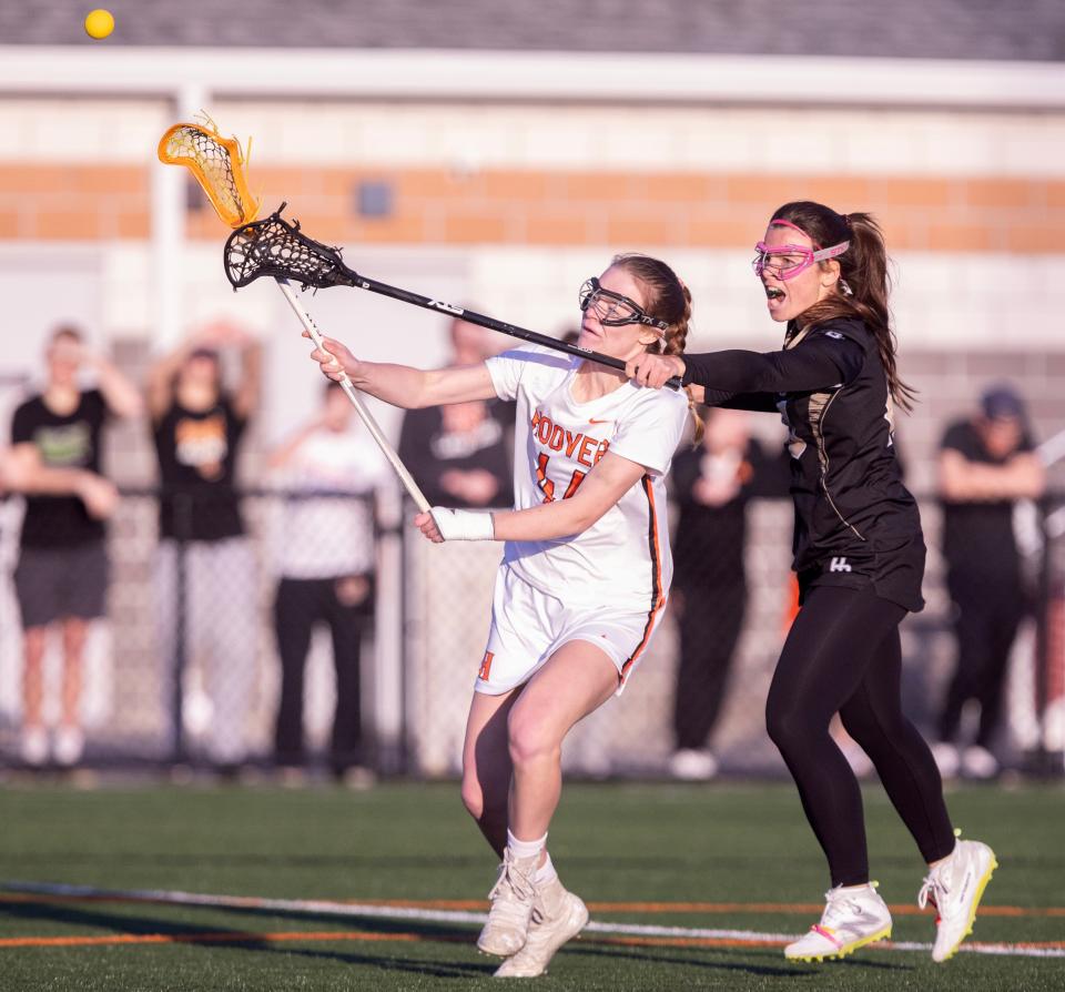 Hoover's Stella Somers scores in the first half with pressure from Hathaway Brown's Veronica Santelli in the first half at Hoover Thursday, April 25, 2024.
