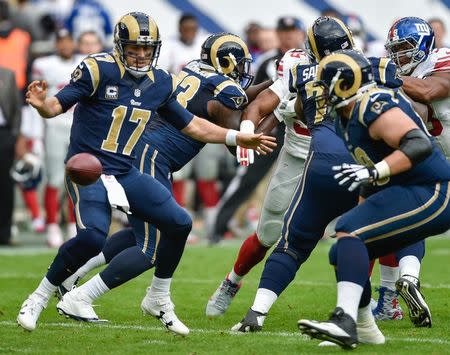 Oct 23, 2016; London, United Kingdom; Los Angeles Rams quarterback Case Keenum (17) the fumbles the ball against the New York Giants during the second quarter at Twickenham Stadium. Mandatory Credit: Steve Flynn-USA TODAY Sports