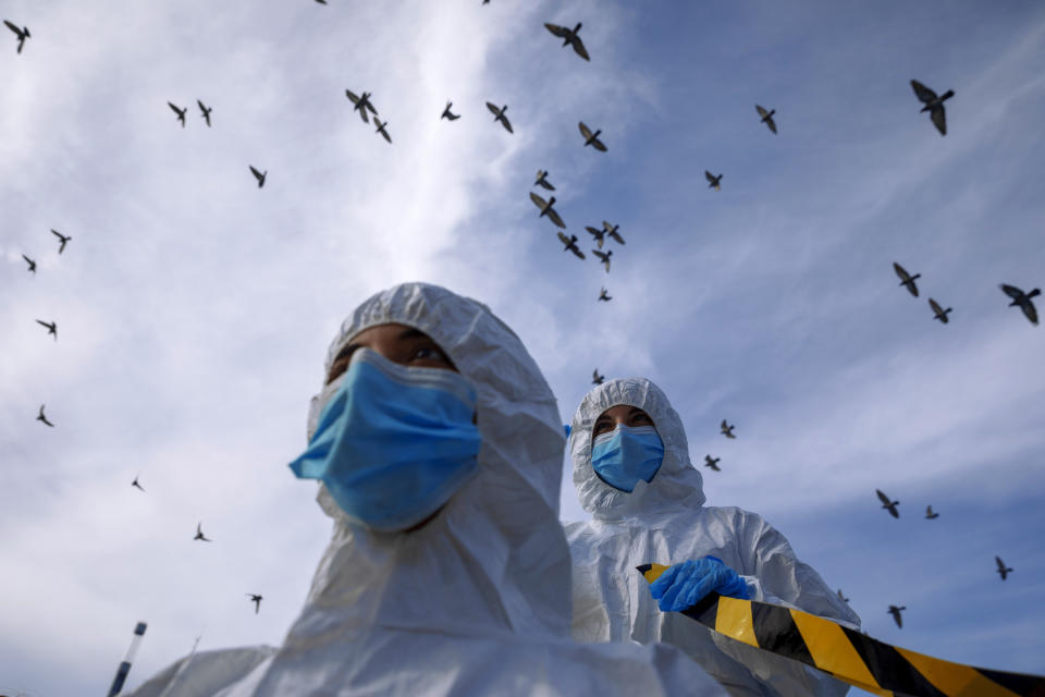 Israeli animal rights activists wearing protective gear demonstrate against the spread of coronavirus among mink in Denmark's fur industry ahead of international Fur Free Friday, in Tel Aviv, Tuesday, Nov. 24, 2020. (AP Photo/Oded Balilty)