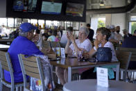 FILE - In this March 24, 2021, file photo, baseball fans gather in the Bullpen Club at George M. Steinbrenner Field before a spring training exhibition baseball game between the New York Yankees and the Toronto Blue Jays in Tampa, Fla. COVID-19 hospitalizations are plunging among older Americans. The falling numbers show the country’s vaccination strategy is working, pushing deaths lower and easing pressure on the frayed hospital system. (AP Photo/Gene J. Puskar, File)