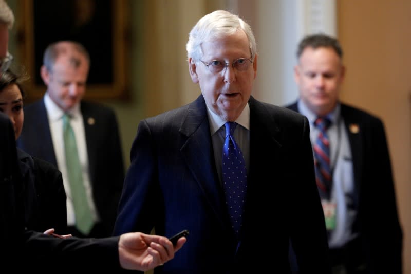 FILE PHOTO: FILE PHOTO: Senate Majority Leader McConnell speaks to members of the news media while walking into his office, as Mayor Muriel Bowser declared a State of Emergency due to the coronavirus disease (COVID-19), on Capitol Hill in Washington