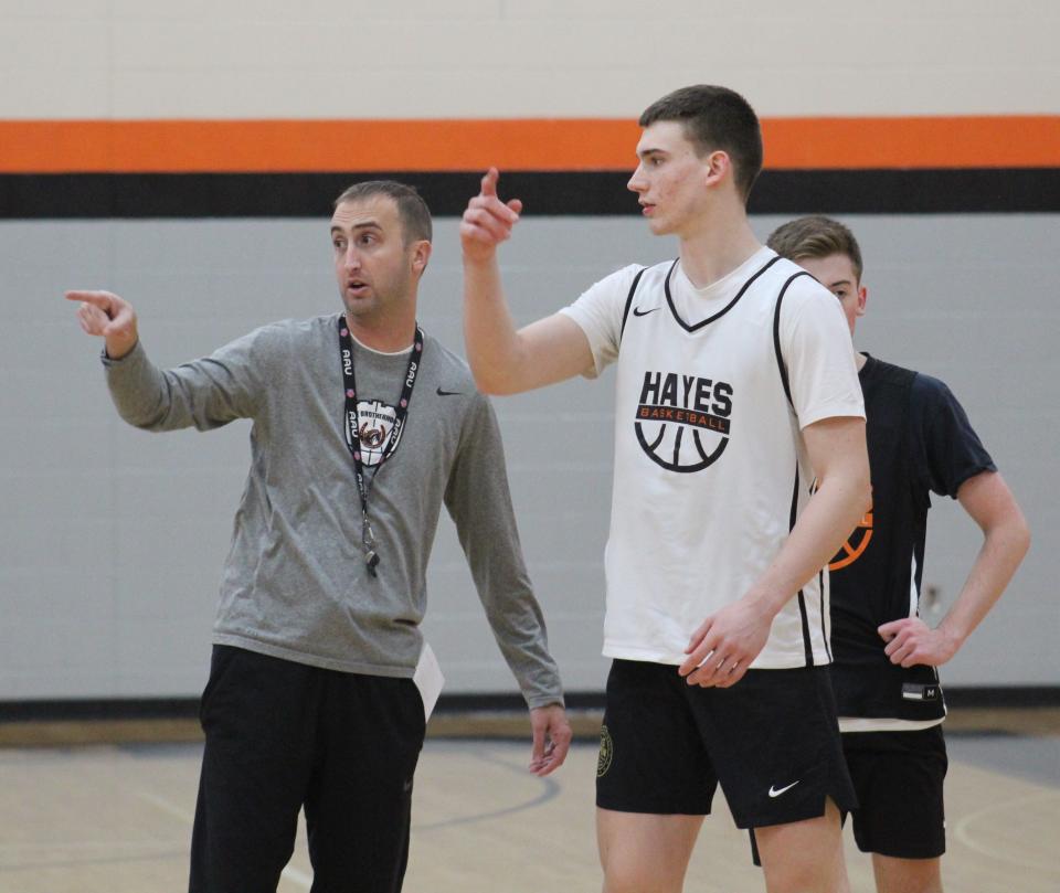 Delaware Hayes boys basketball coach Adam Vincenzo instructs Landon Vanderwarker during a recent practice.