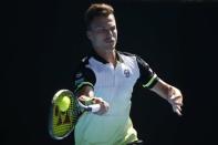 Tennis - Australian Open - Rod Laver Arena, Melbourne, Australia, January 22, 2018. Marton Fucsovics of Hungary hits a shot against Roger Federer of Switzerland. REUTERS/Thomas Peter