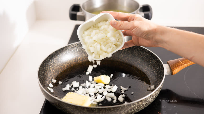 chopped onion going into pan