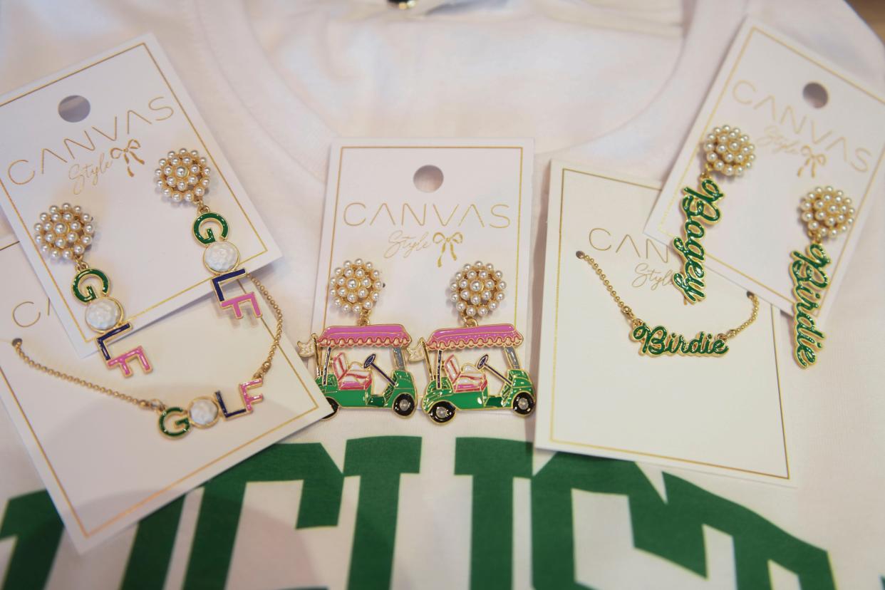 Golf earrings sit on display at My Story Boutique, located off Cabela Drive, in Augusta on Tuesday, March 26, 2024.