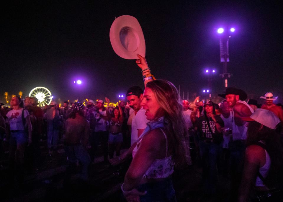 Becca Kremer of San Francisco dances in the crowd with her fiance, Kevin Shepley, as Morgan Wallen performs his headlining set on the Mane Stage during Stagecoach country music festival in Indio, Calif., Sunday, April 28, 2024.