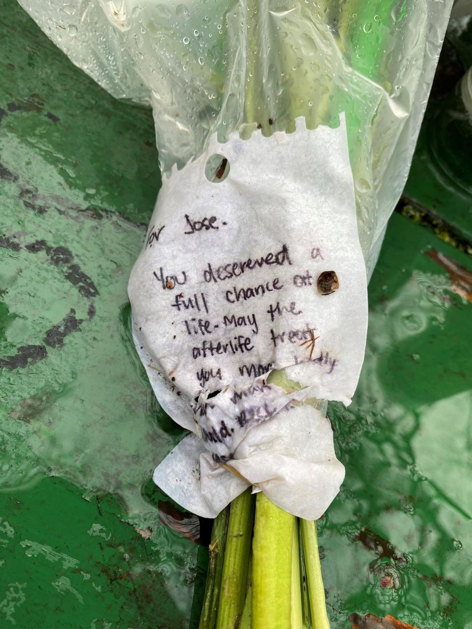 A hand-written note is wrapped around a bouquet of flowers left on a picnic table at Bush's Pasture Park where 16-year-old South Salem High School student Jose Vasquez-Valenzuela was fatally shot March 7.