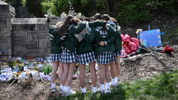 PHOTO: Girls embrace in front of a makeshift memorial for victims near the Covenant School building at the Covenant Presbyterian Church following a shooting that killed six, in Nashville, Tenn., March 28, 2023. (Brendan Smialowski/AFP via Getty Images)