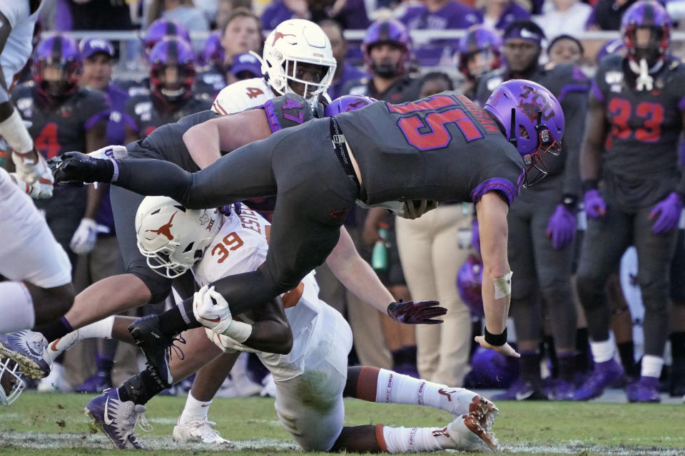 TCU quarterback Max Duggan (15) is tackled by Texas defensive back Montrell Estell (39) in the second half of an NCAA college football game in Fort Worth, Texas, Saturday, Oct. 26, 2019. (AP Photo/Louis DeLuca)